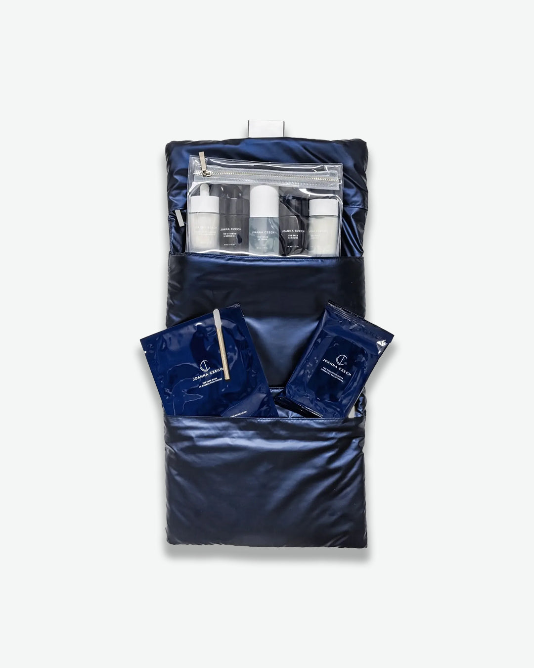 Navy toiletry bag with travel-sized products on a white background