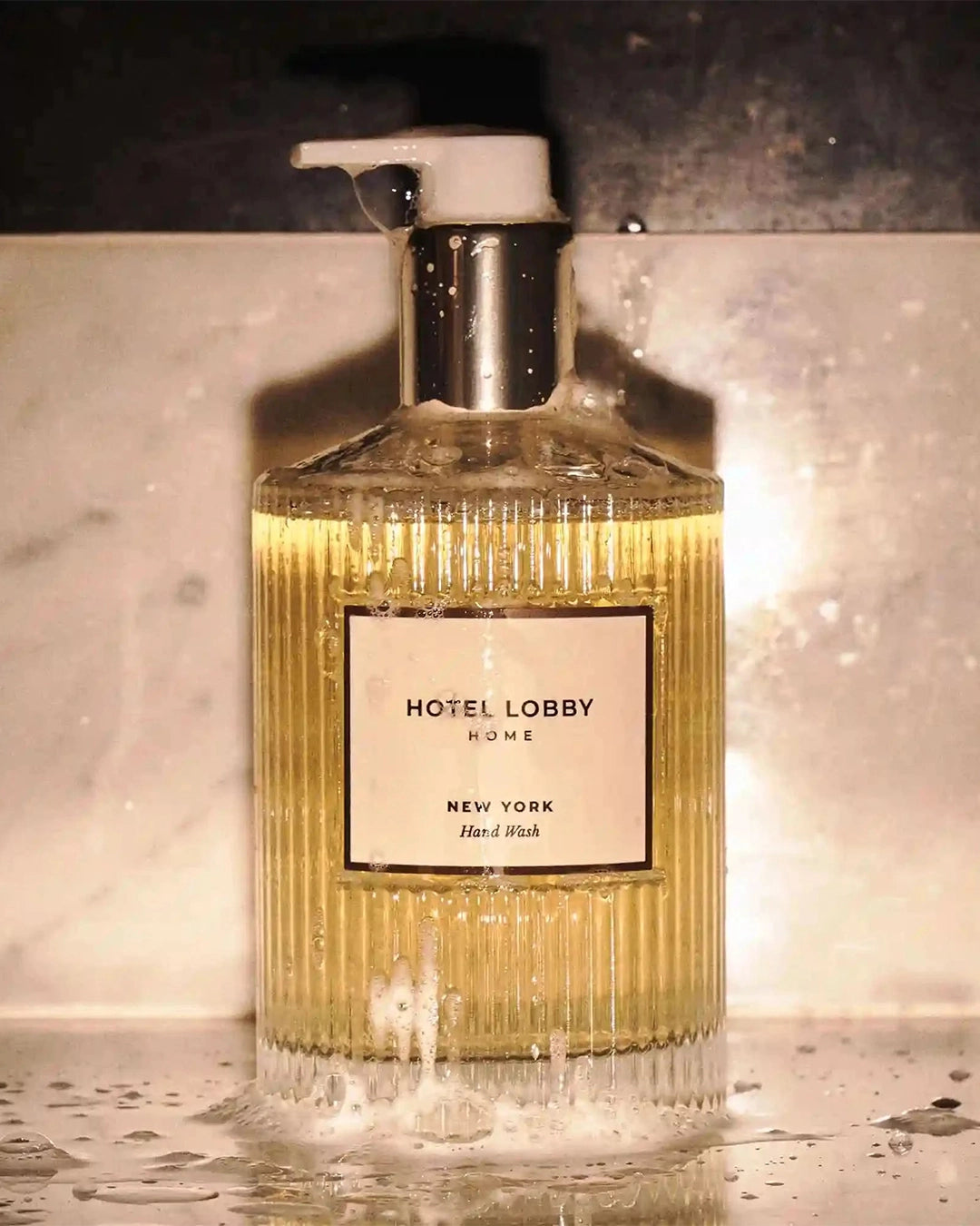 Bottle of Hotel Lobby Home hand wash on a marble surface