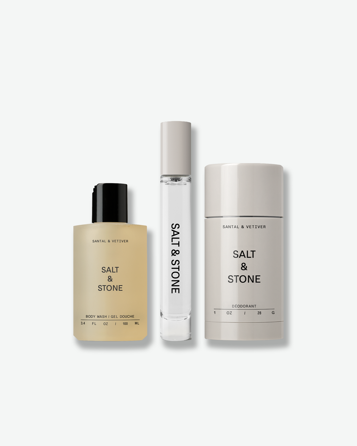 SALT & STONE Santal & Vetiver Signature Trio featuring body wash, body mist, and deodorant in minimalist beige and neutral-toned packaging on a light gray background.