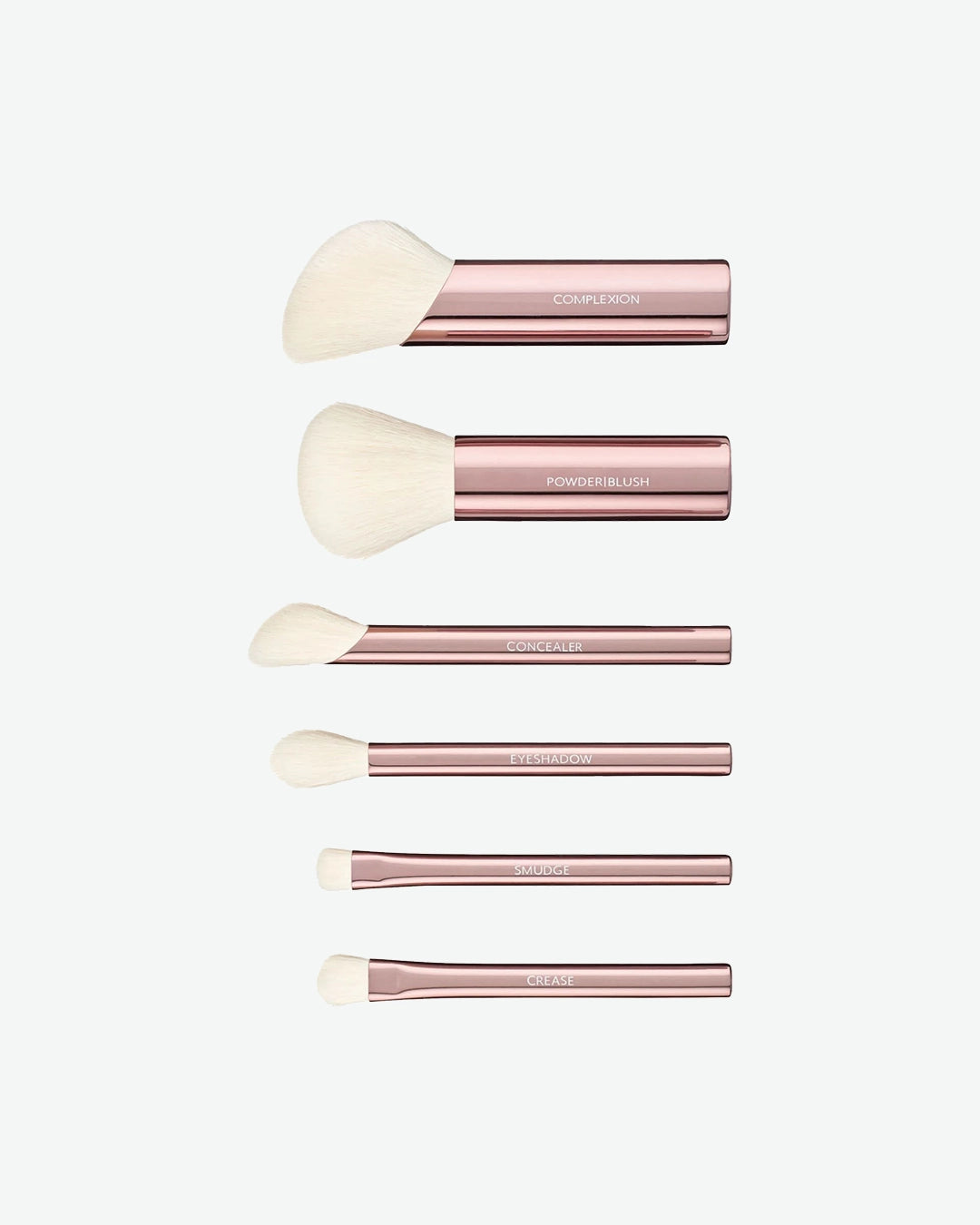 Set of five makeup brushes with rose gold handles on a white background