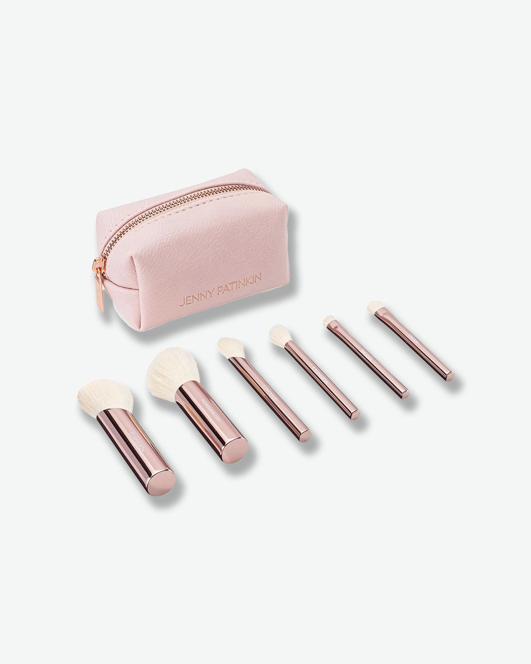 Set of rose gold makeup brushes with a matching pink pouch on a white background
