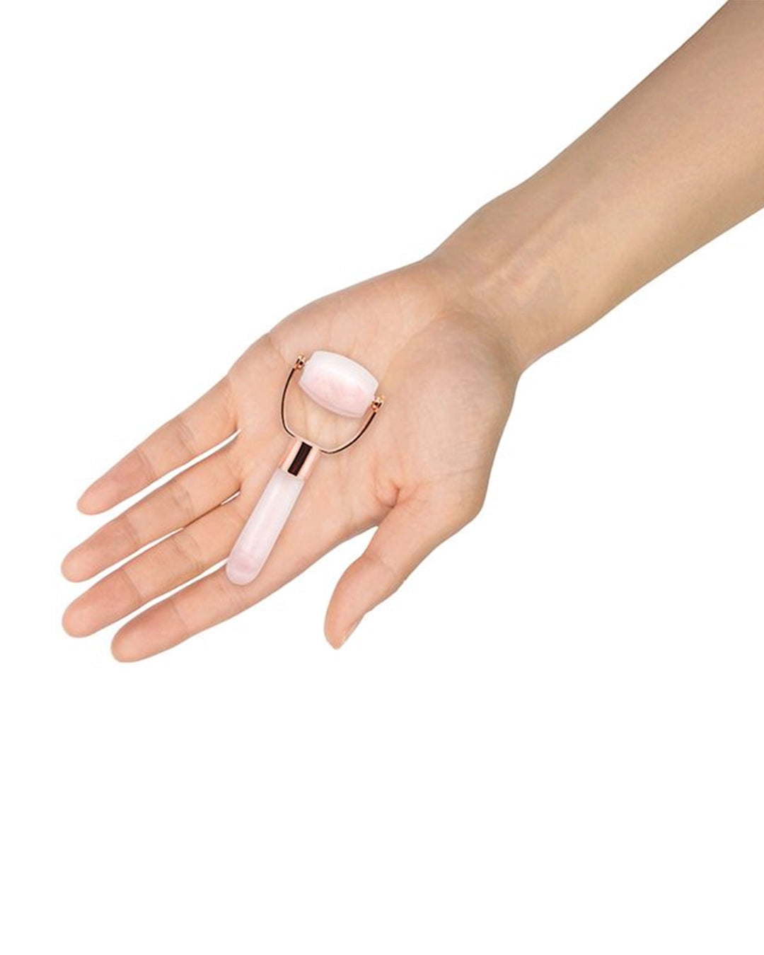 Hand holding a pink roller device on a white background