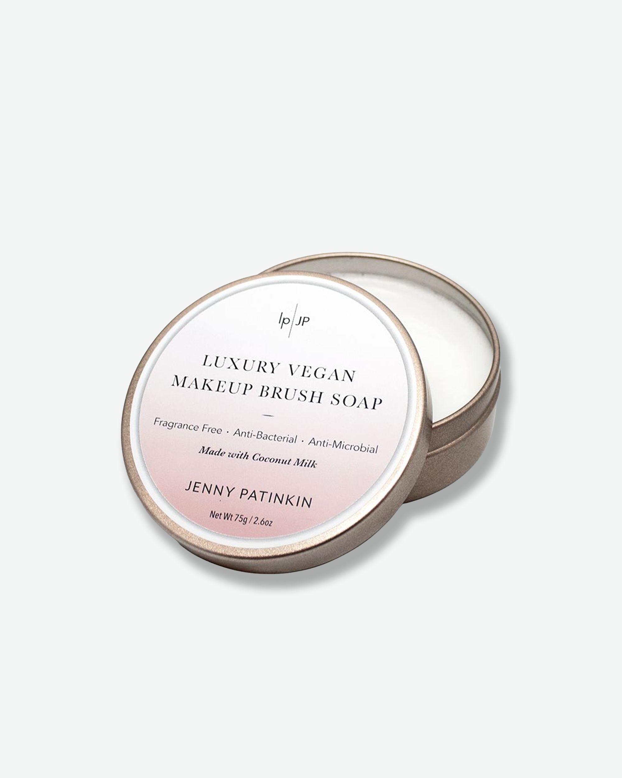 Luxury vegan makeup brush soap packaging with brand name on a light gray background
