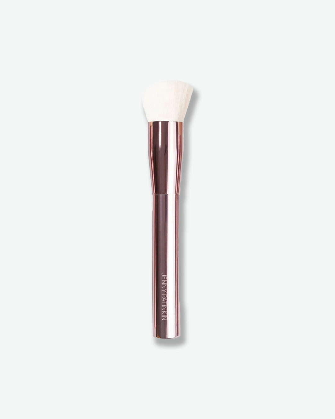 Makeup brush with a rose gold handle on a white background