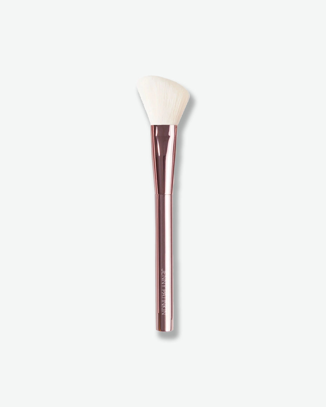 Makeup brush with a rose gold handle on a white background