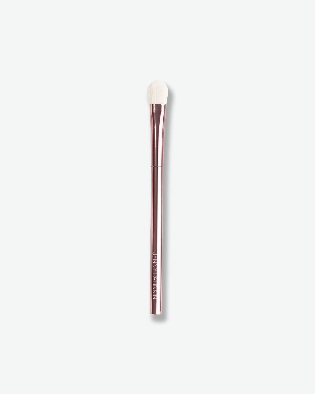 Makeup brush with a white bristle head and brown handle on a light gray background