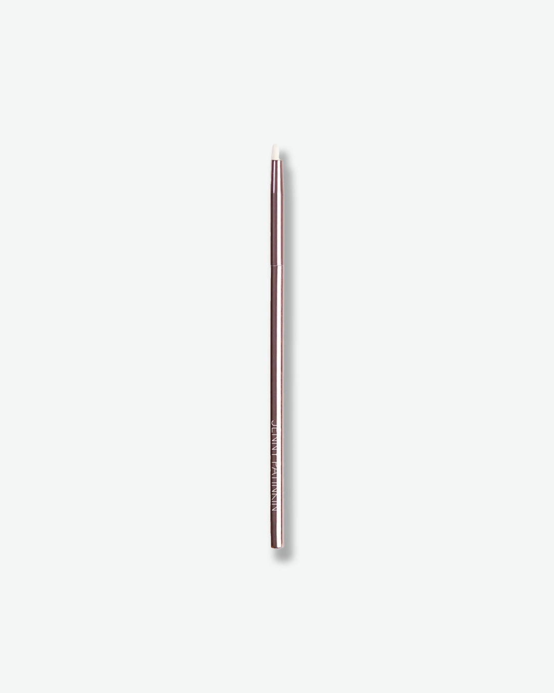 A precision eye makeup brush is displayed against a light gray background. The brush features a metallic rose-toned handle and a small angled white bristle tip, designed for detailed application along the lash line, brows, or outer corners of the eyes. Its slim, professional design allows for precise placement and definition.