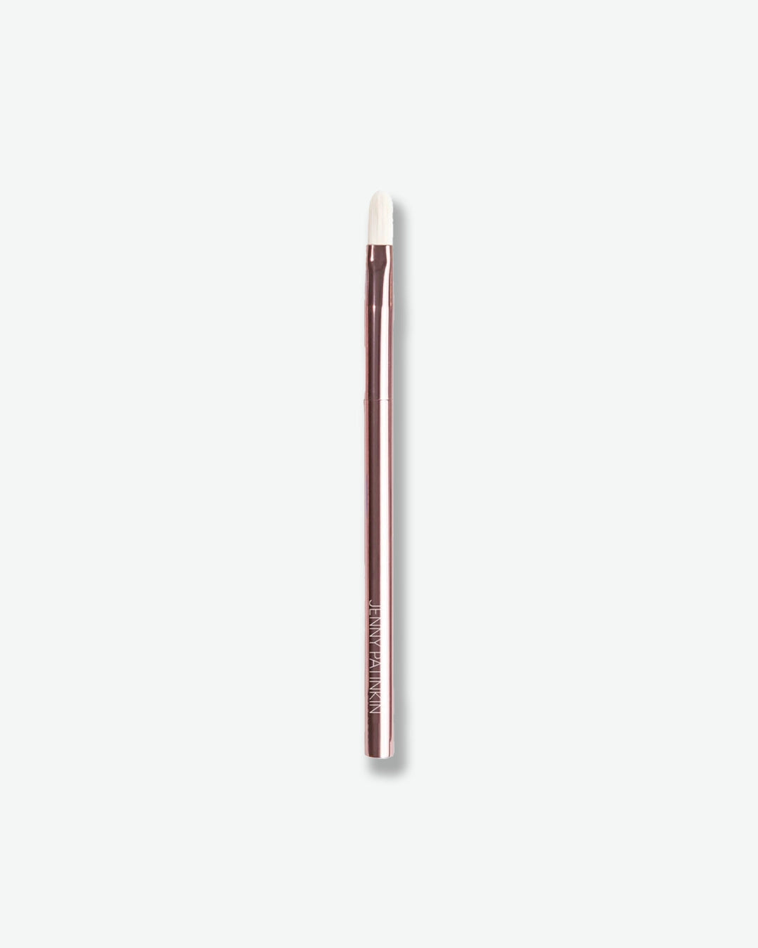 Makeup brush with a brown handle and white bristle head on a light gray background