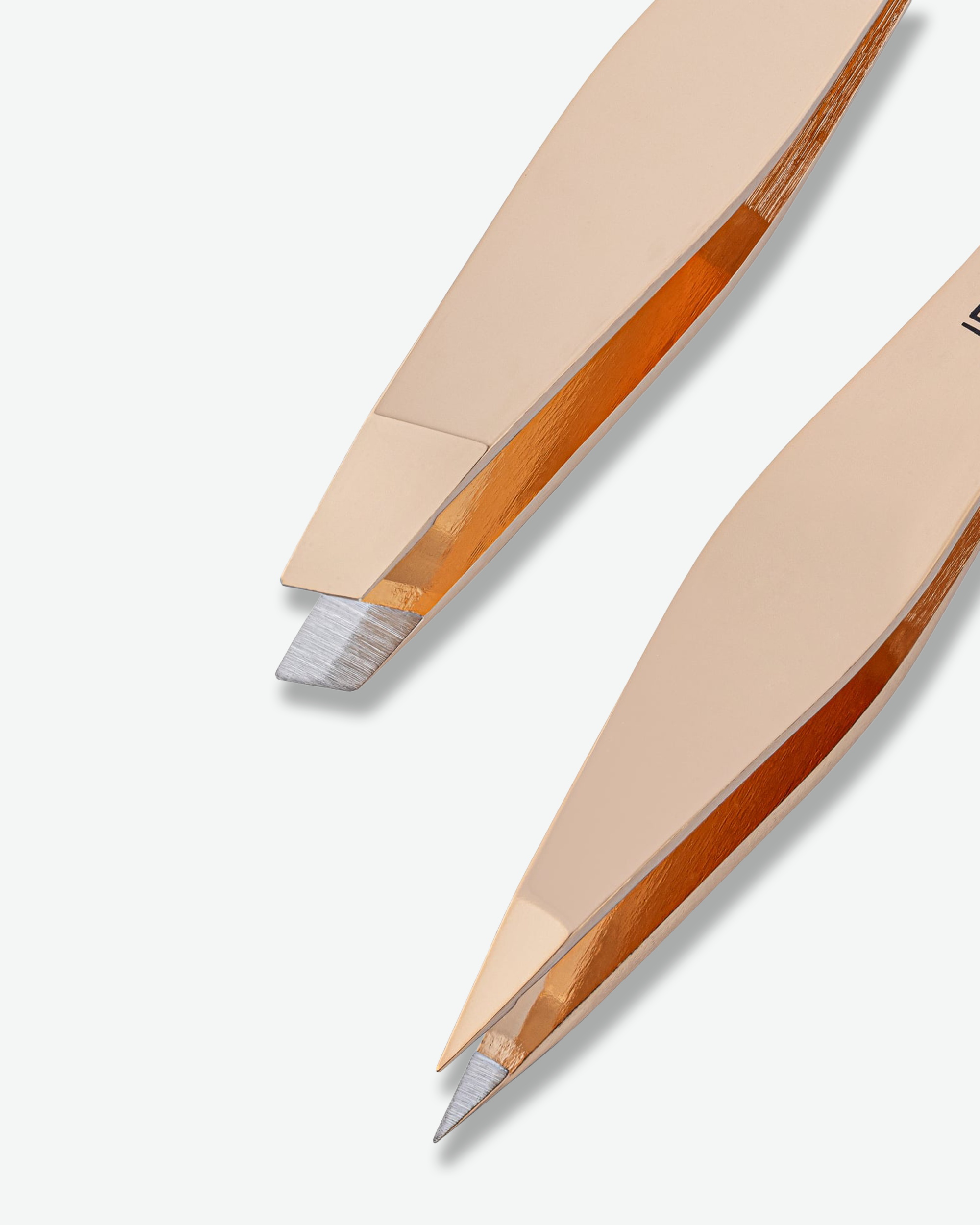 Close-up of two metallic rose gold flat tweezers with silver stainless steel tips, shown on a clean off-white background.