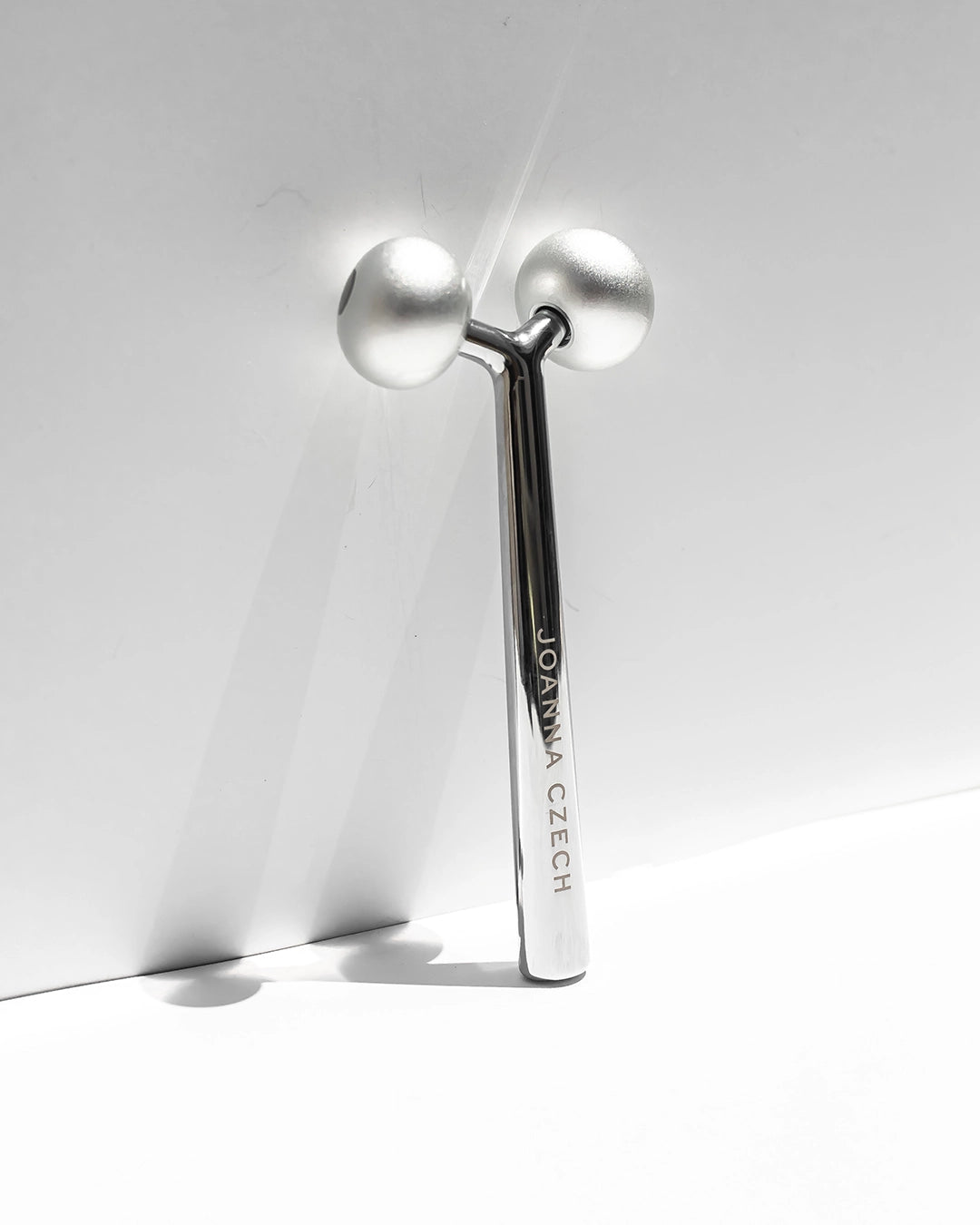 Skincare tool with 'Joanna Czech' branding on a white background