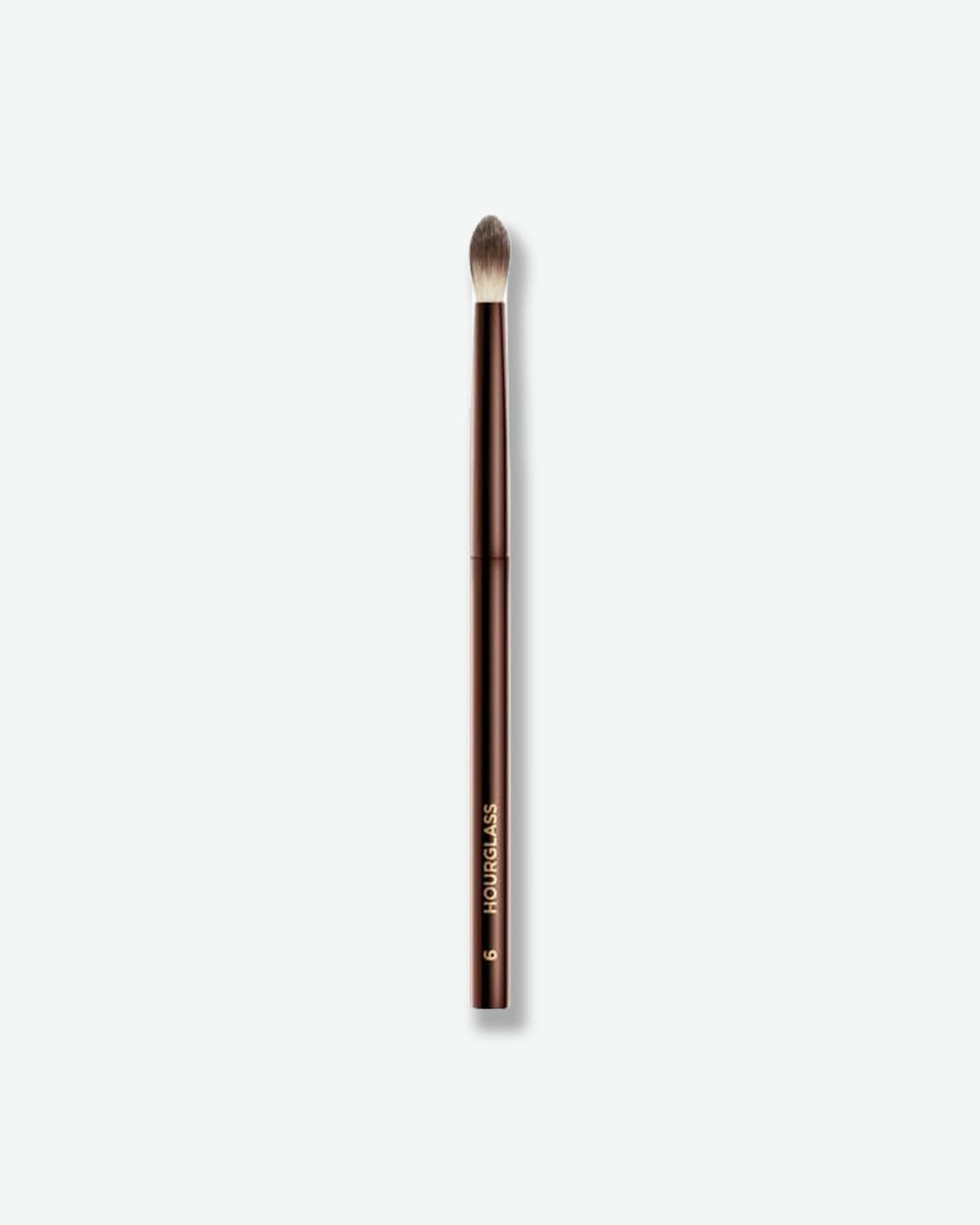 Makeup brush with a brown handle and black bristle head on a white background