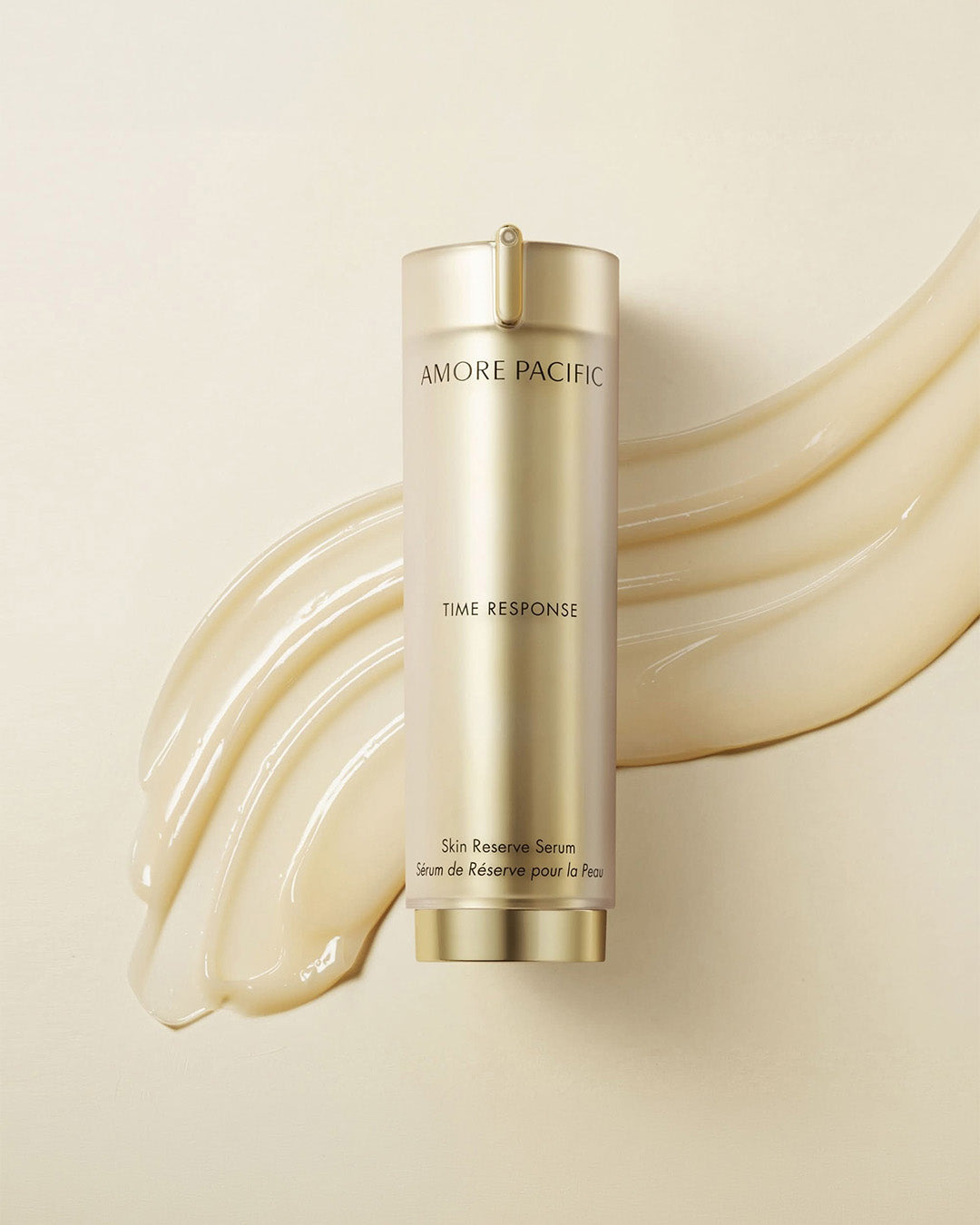 Gold Amore Pacific Time Response serum bottle with a texture swatch on a beige background