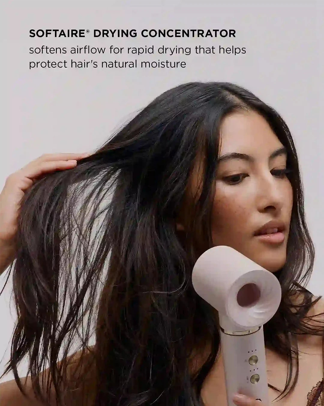 Woman using a SOFTAIRE drying concentrator on her hair with text about its benefits.