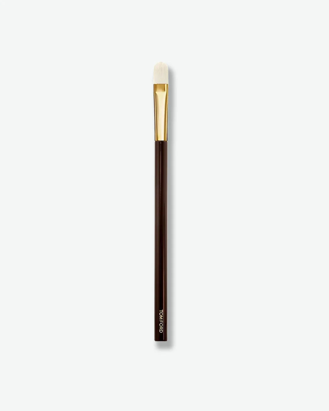 Makeup brush with brown handle and gold ferrule on a white background