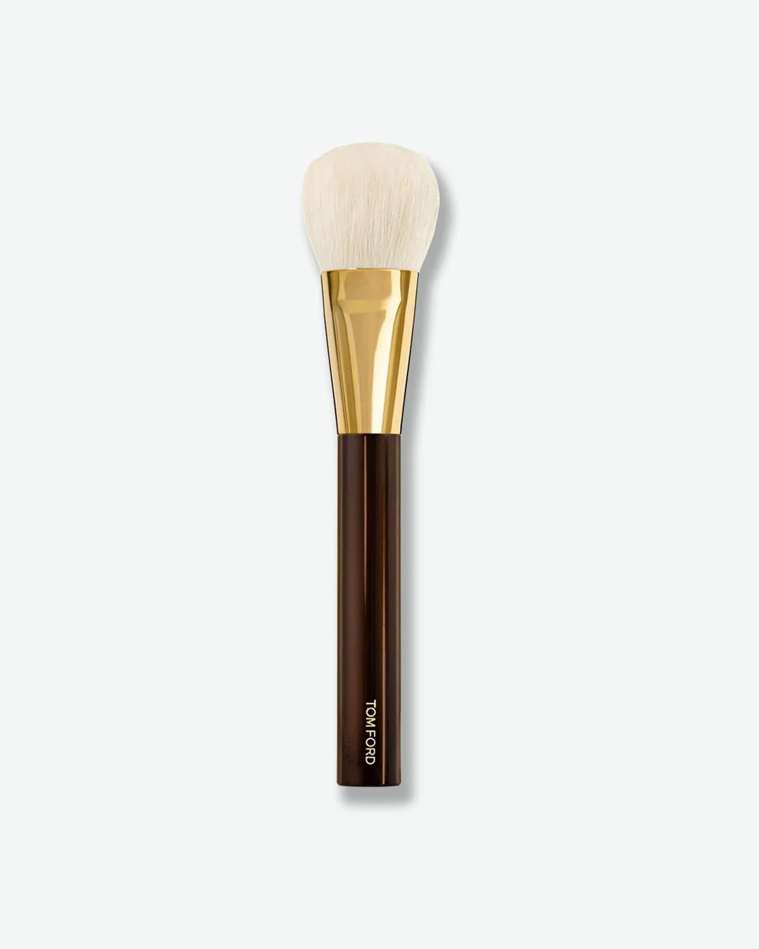 Makeup brush with gold and brown handle on a white background