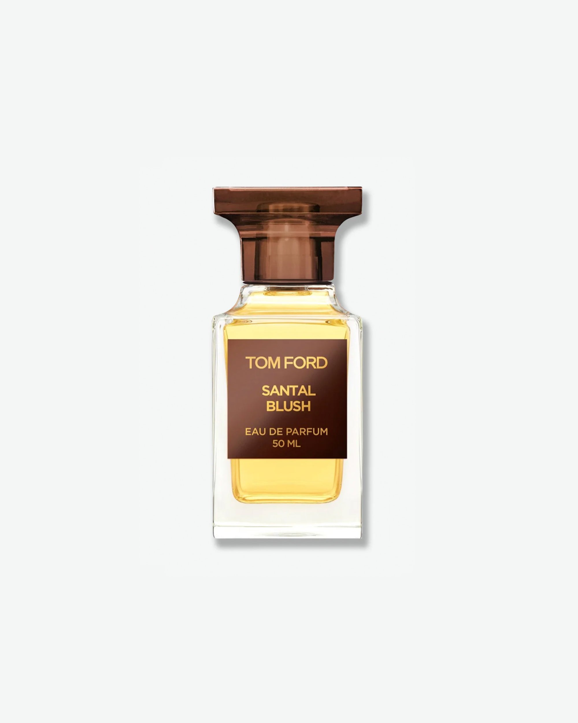 Product shot of Tom Ford Santal Blush Eau de Parfum. The fragrance is housed in a 50ml clear architectural glass bottle that reveals a golden yellow liquid inside. The bottle features a square dark brown label with gold font and is topped with a translucent brown cap, casting a soft shadow against a solid light grey background.