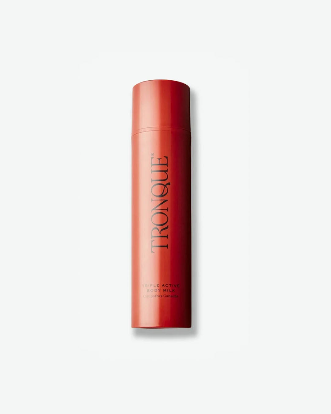 A vertical product shot of Tronque Triple Active Body Milk (Cleopatra's Ganache). The product is packaged in a sleek, minimalist cylindrical bottle in a matte crimson red, featuring the brand name "TRONQUE" printed vertically in a black, serif font.