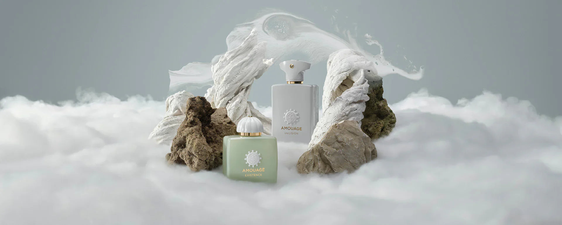 Amouage Existence and Decision fragrances displayed among sculptural white rock formations and soft clouds, creating an ethereal luxury fragrance landscape inspired by nature, eternity, and the sky.