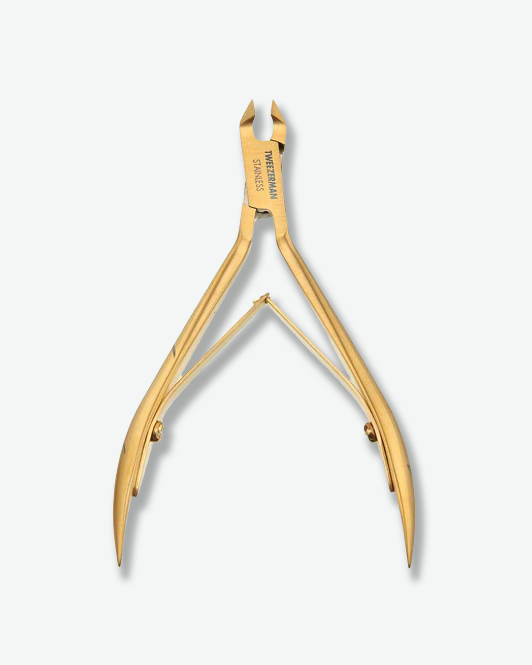 Front view of a pair of open Tweezerman cuticle nippers standing against a plain gray background. The precision manicure tool is crafted with a luxurious brushed gold metallic finish and is engraved with "TWEEZERMAN STAINLESS" on the joint.