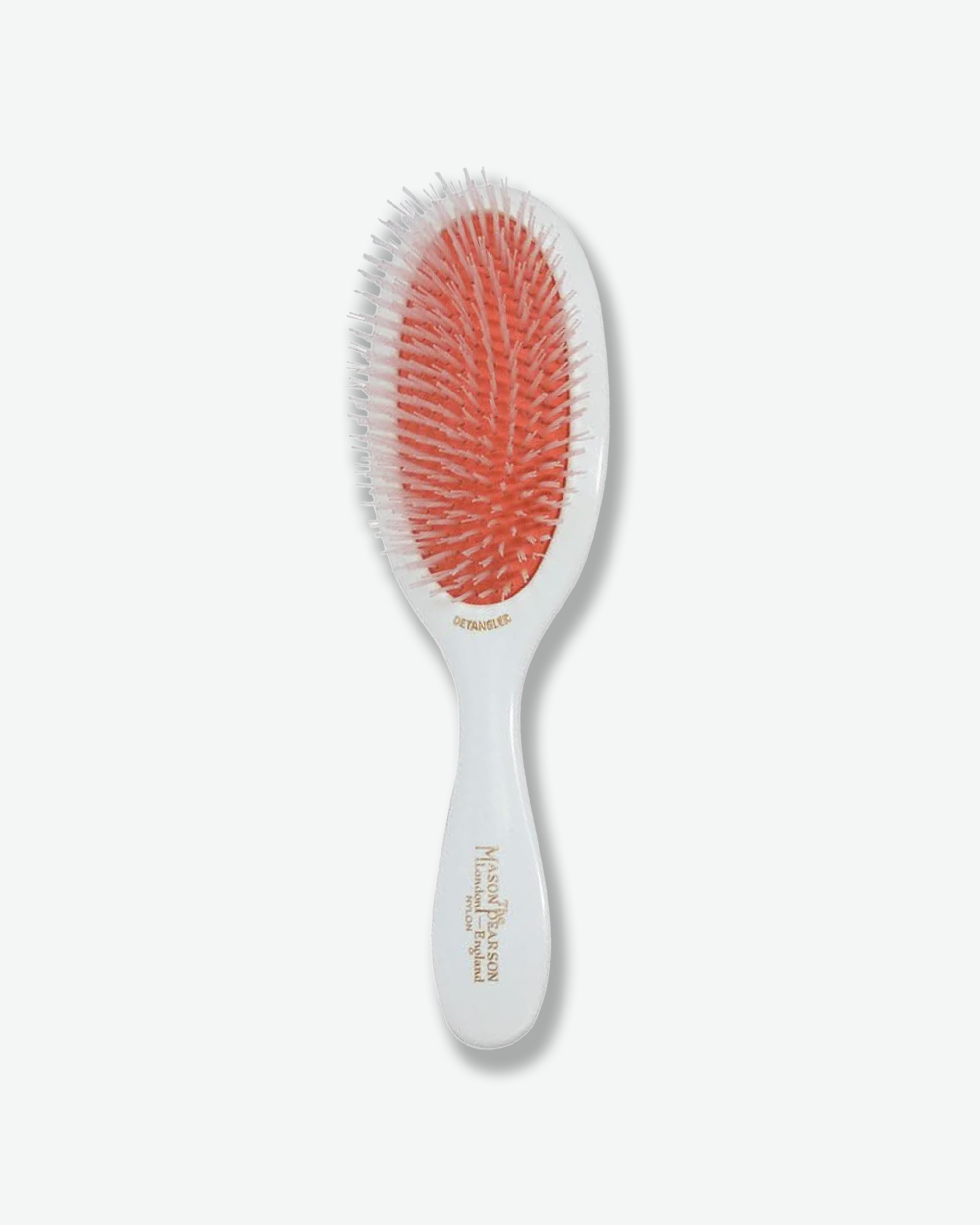 Top-down view of a Mason Pearson wide-tooth dressing comb featuring a polished tortoiseshell acrylic design with gold branding text reading "Mason Pearson London England".