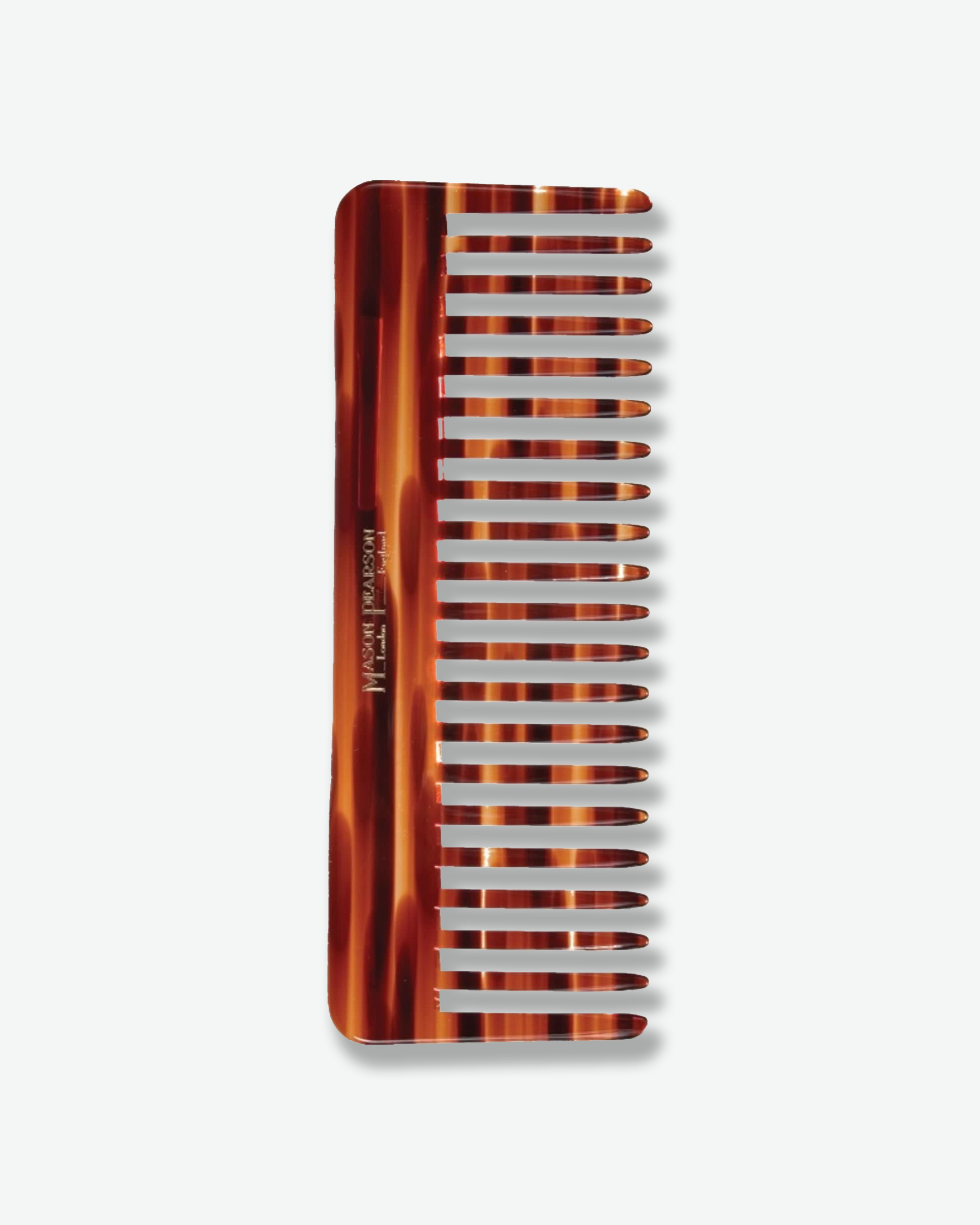 Front view of a small Mason Pearson pocket-sized dark ruby oval hairbrush featuring a bright orange rubber cushion, black pure boar bristles, and gold handle text reading "The Mason Pearson London - England Pure Bristle".