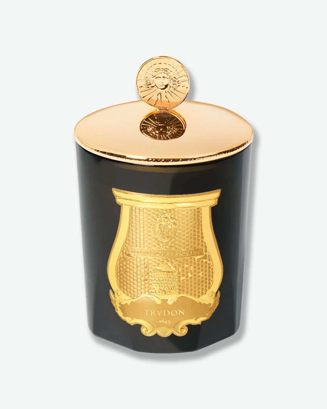 Black and gold candle with 'Cire Trudon' branding on a white background