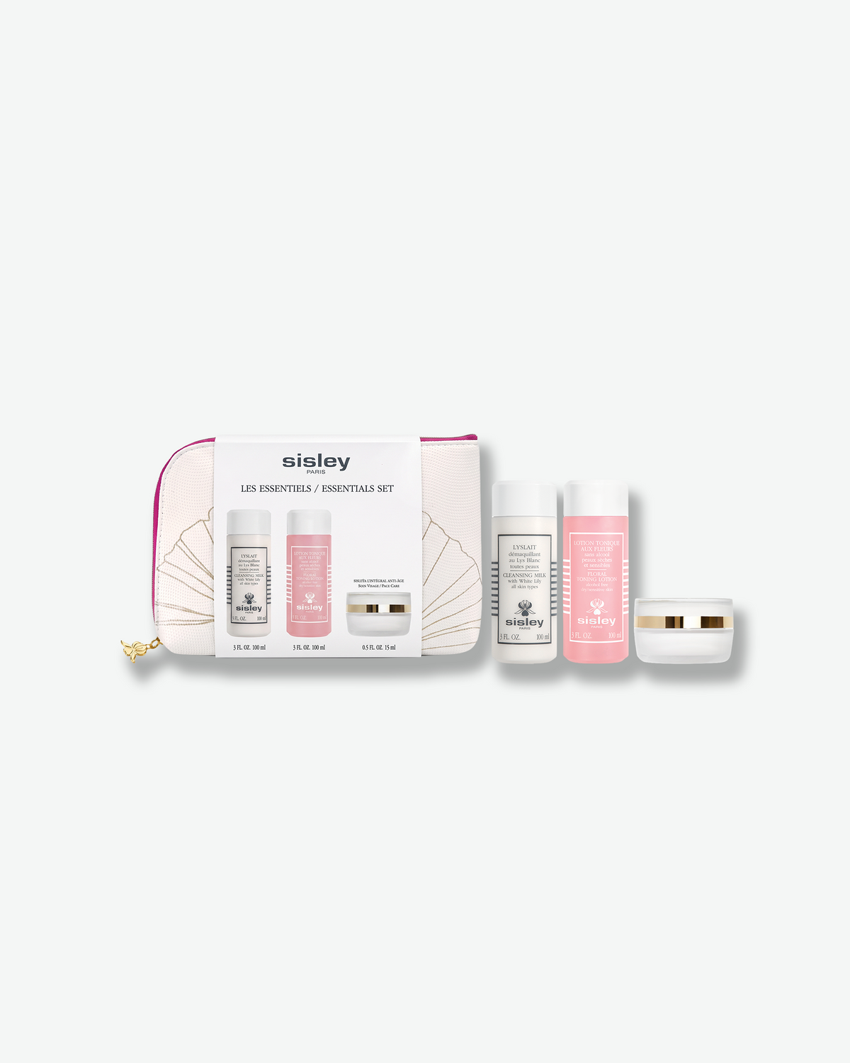 A Sisley Paris Essentials Set featuring three skincare travel items—a white bottle, a pink bottle, and a white cream jar—displayed alongside a white zippered cosmetic pouch with gold fan illustrations.