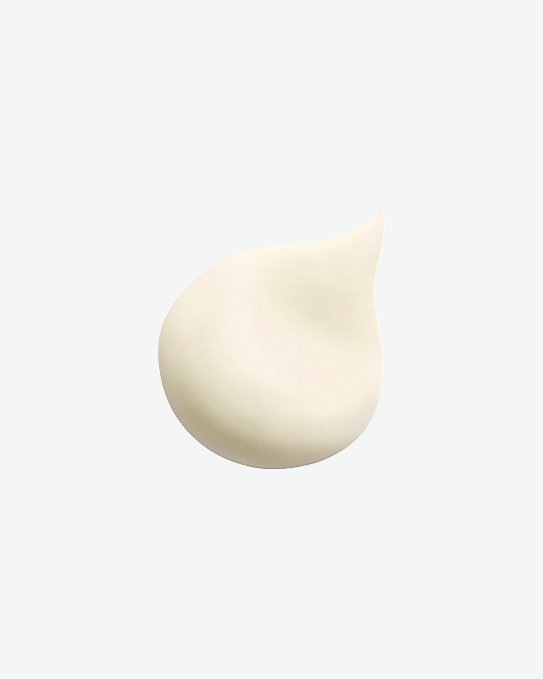 A smooth dollop of off-white cream texture isolated on a solid white background.