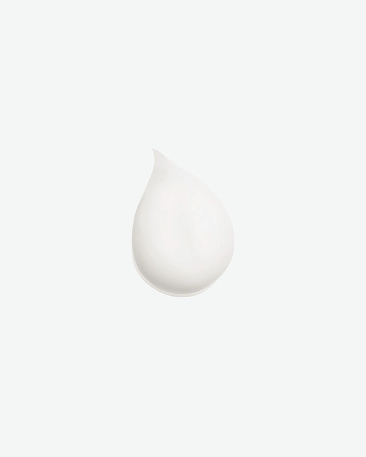 White ceramic teardrop-shaped vase on a light beige background