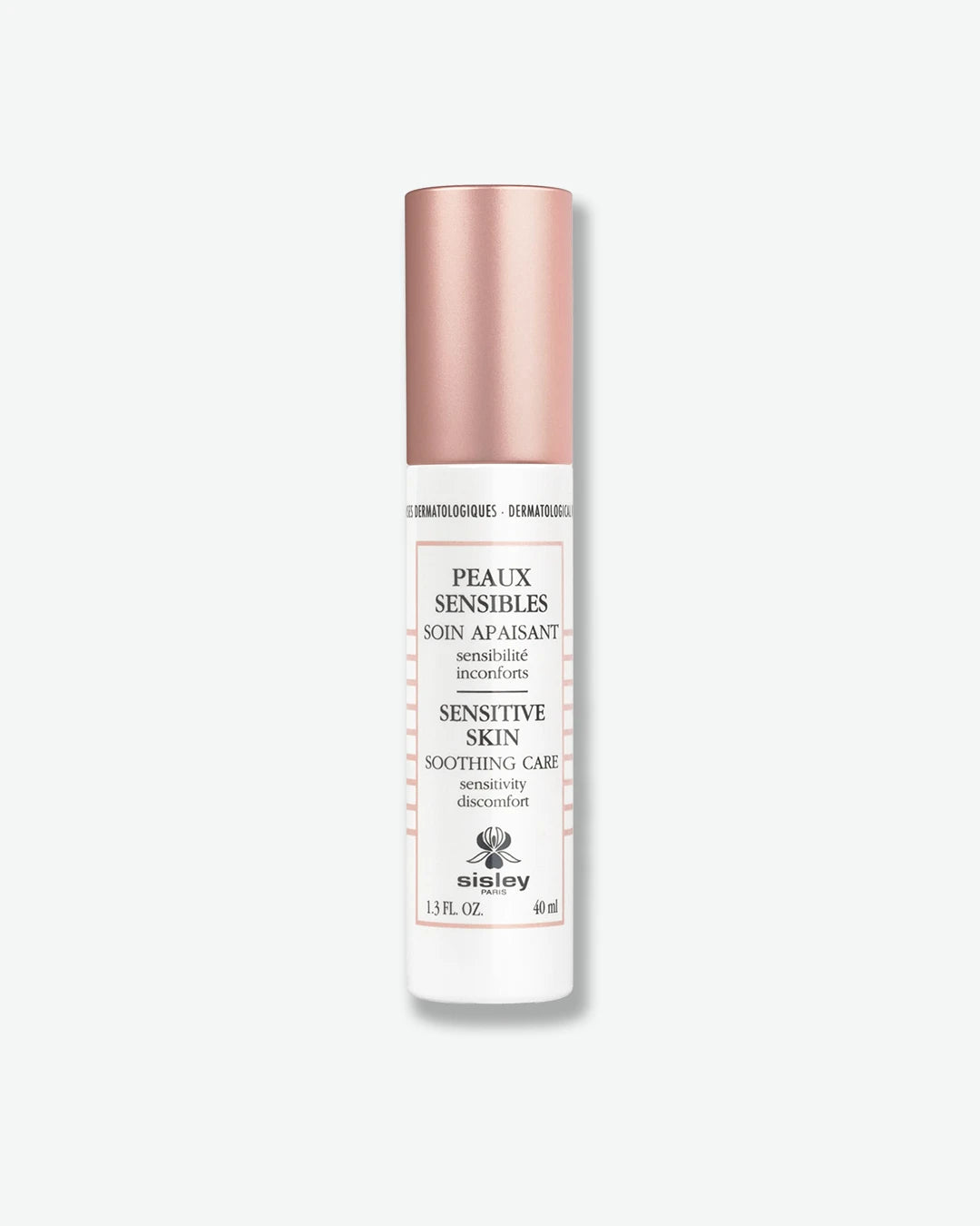 A slender white bottle of Sisley Paris Sensitive Skin Soothing Care lotion, topped with a smooth, metallic rose gold cap.