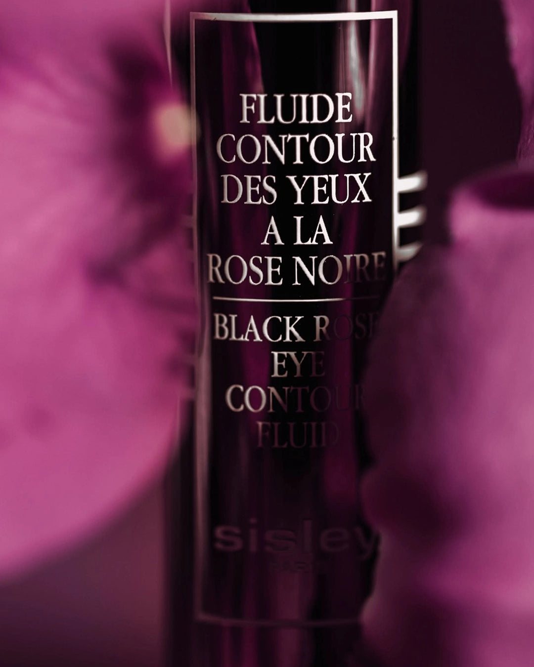 Sisley Black Rose Eye Contour Fluid bottle with pink floral background