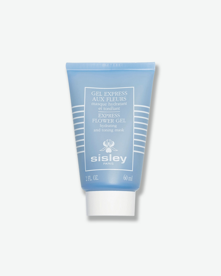 Front view of a Sisley Paris Express Flower Gel mask tube against a plain gray background. The vertical squeeze tube is a matte, soft periwinkle blue with white horizontal lines stacked on the sides, white product details centered in a frame, and a solid white screw cap.