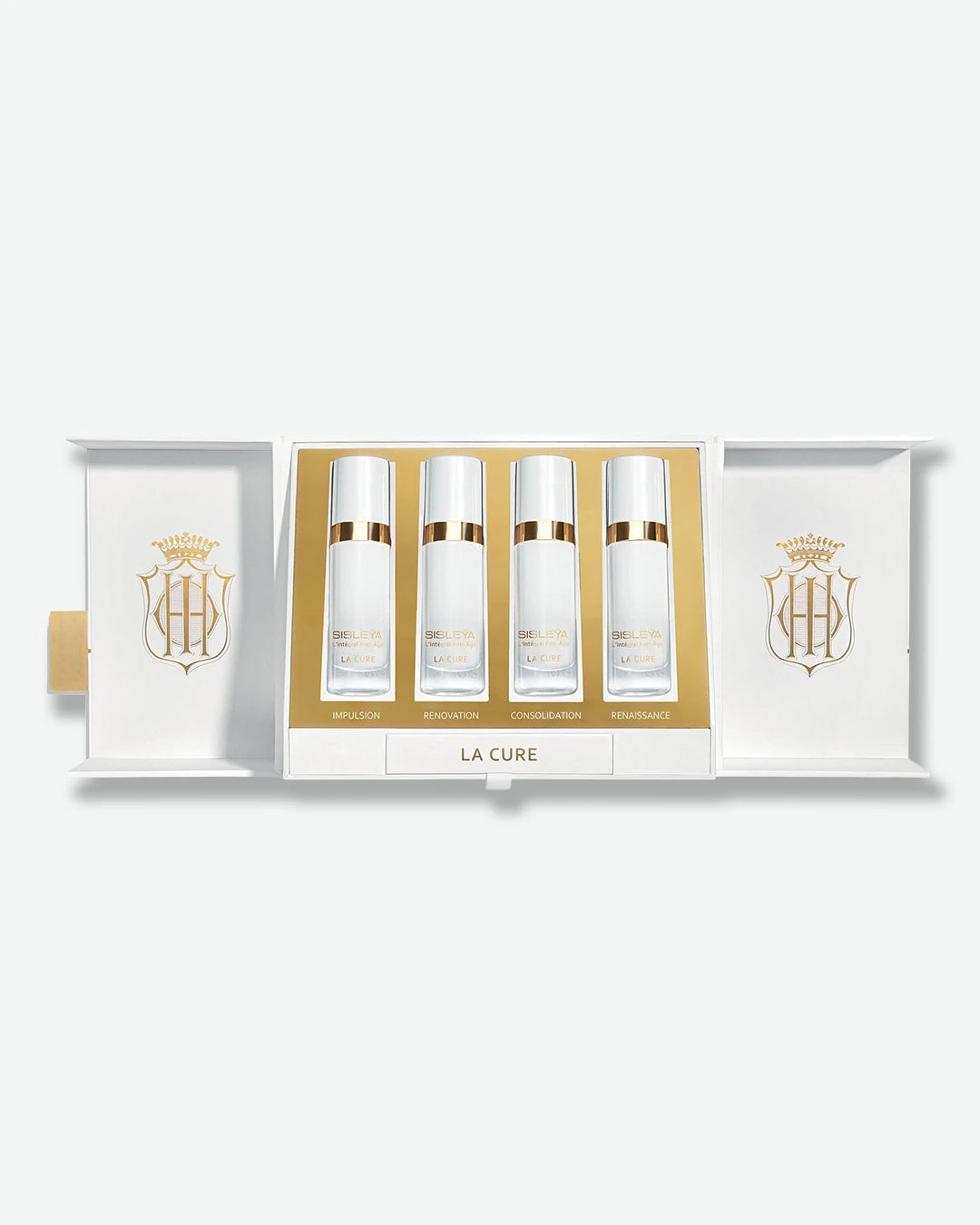 An open presentation box of Sisley Paris Sisleÿa L'Intégral Anti-Âge La Cure, revealing four white and gold serum bottles arranged horizontally in a metallic gold tray.