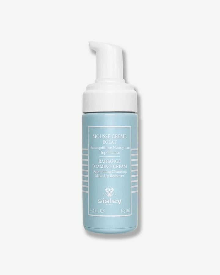 A matte, light pastel blue bottle of Sisley Paris Radiance Foaming Cream cleanser, uncovered to reveal its white plastic foam-dispensing pump.