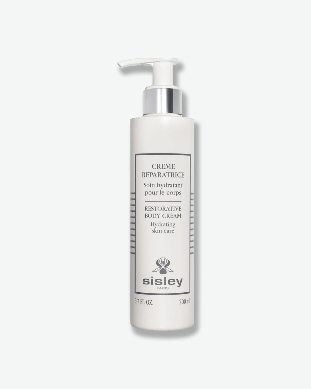 A matte white pump bottle of Sisley Paris Restorative Body Cream (Crème Réparatrice), featuring a metallic silver collar and a white dispenser pump.