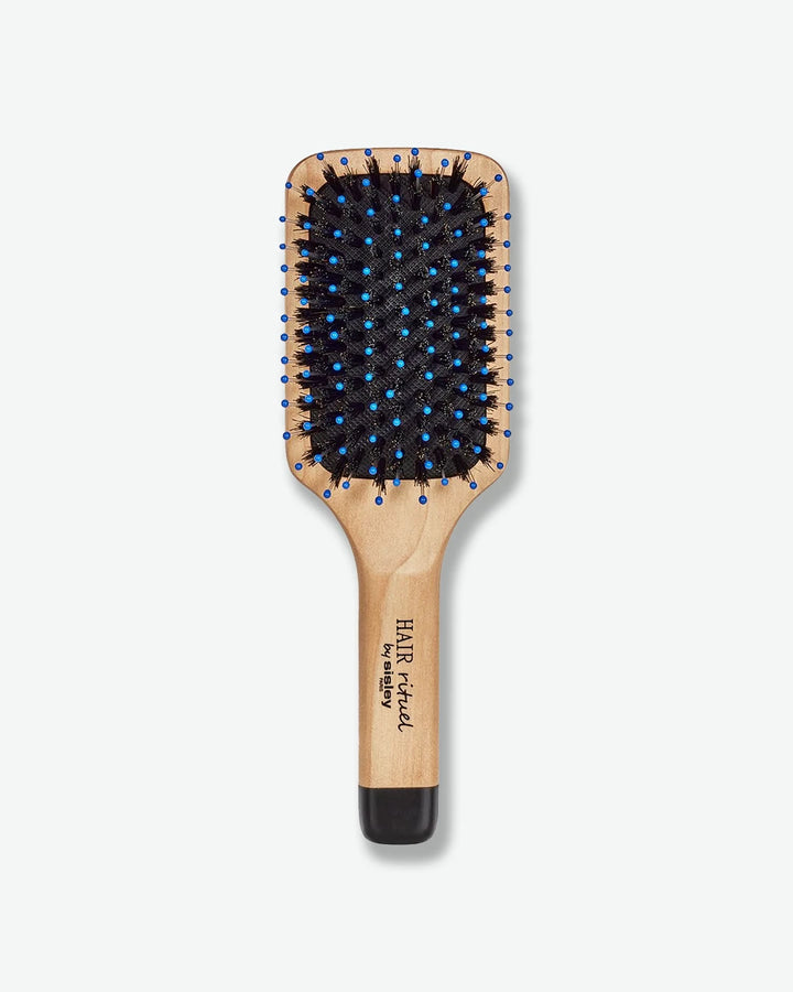 Wooden paddle hairbrush with black bristles on a white background