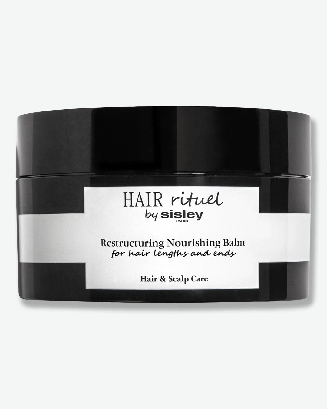 Black jar of Hair Ritual by Sisley Restructuring Nourishing Balm on a white background
