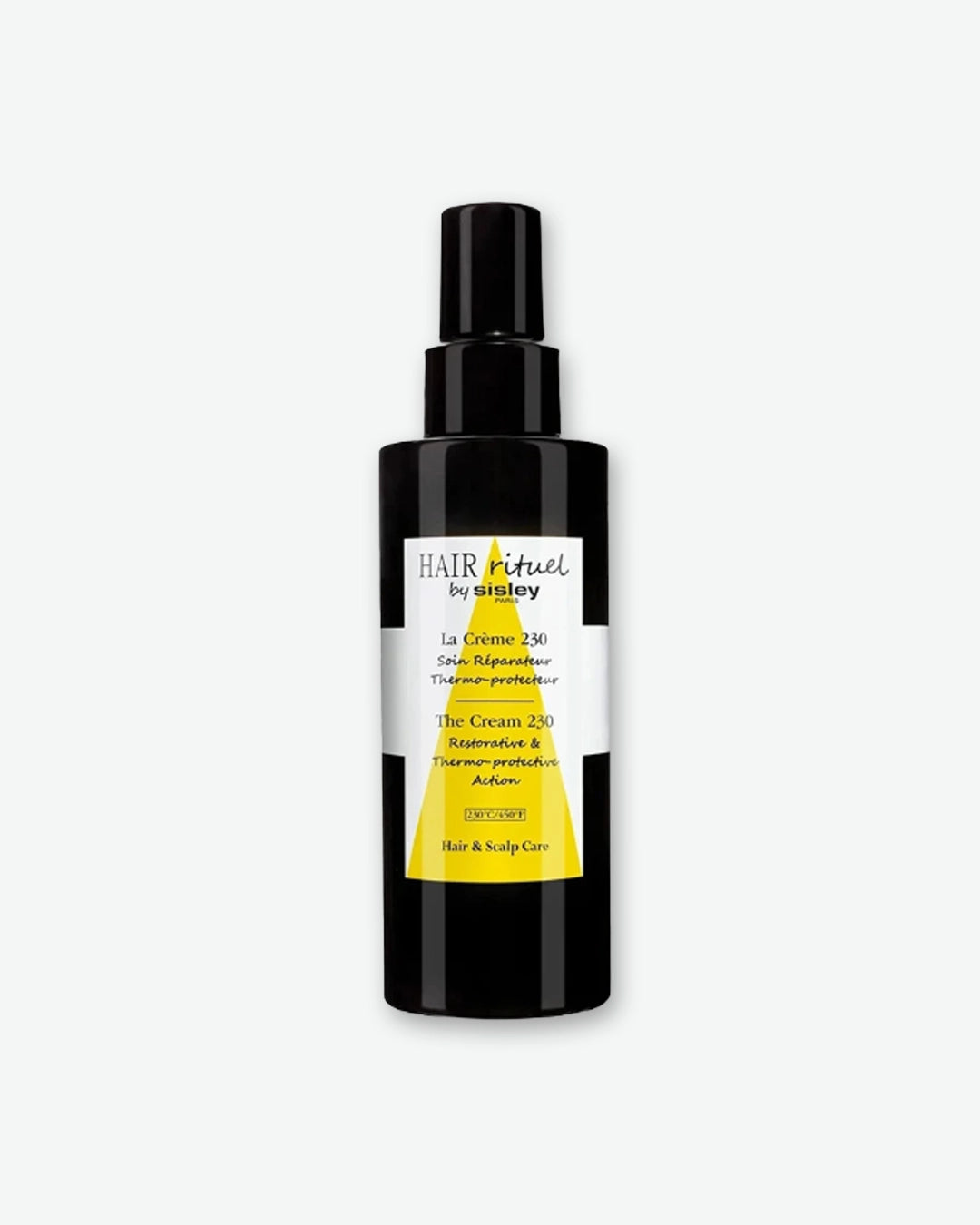 A bottle of HAIR Rituel by Sisley The Cream 230, featuring a sleek, black pump bottle with a distinctive white label and a large yellow triangular design.