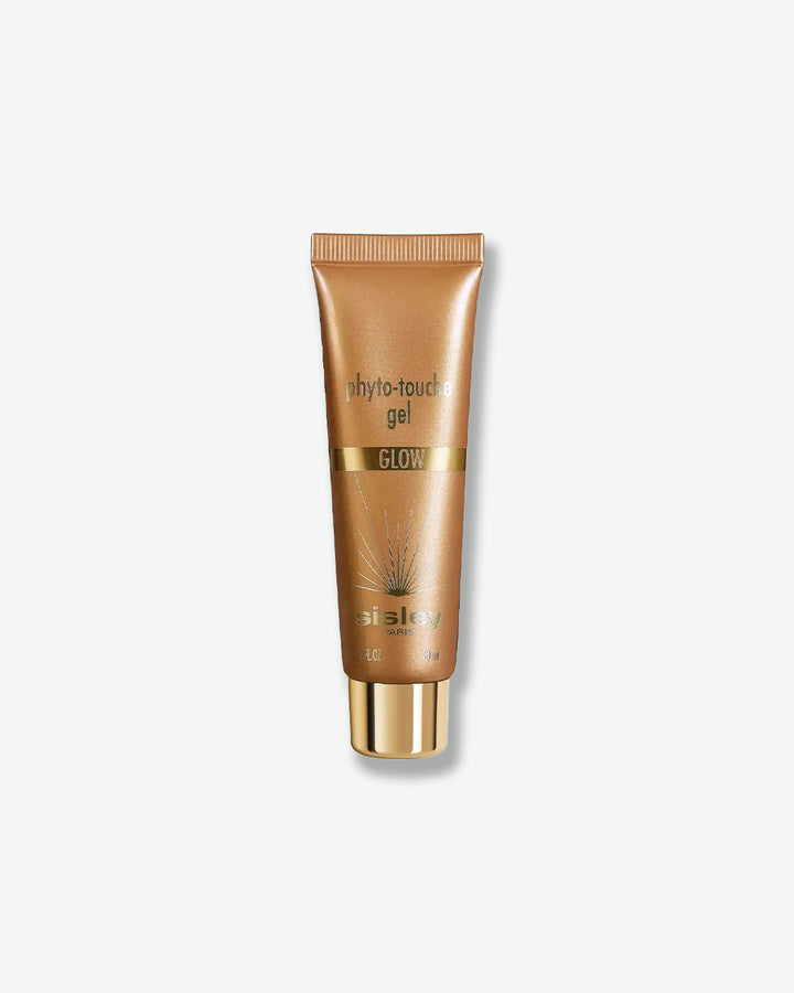 A shimmery metallic bronze squeeze tube of Sisley Paris Phyto-Touche Gel Glow sun-kissed hydrating gel, resting vertically on a shiny gold cap.