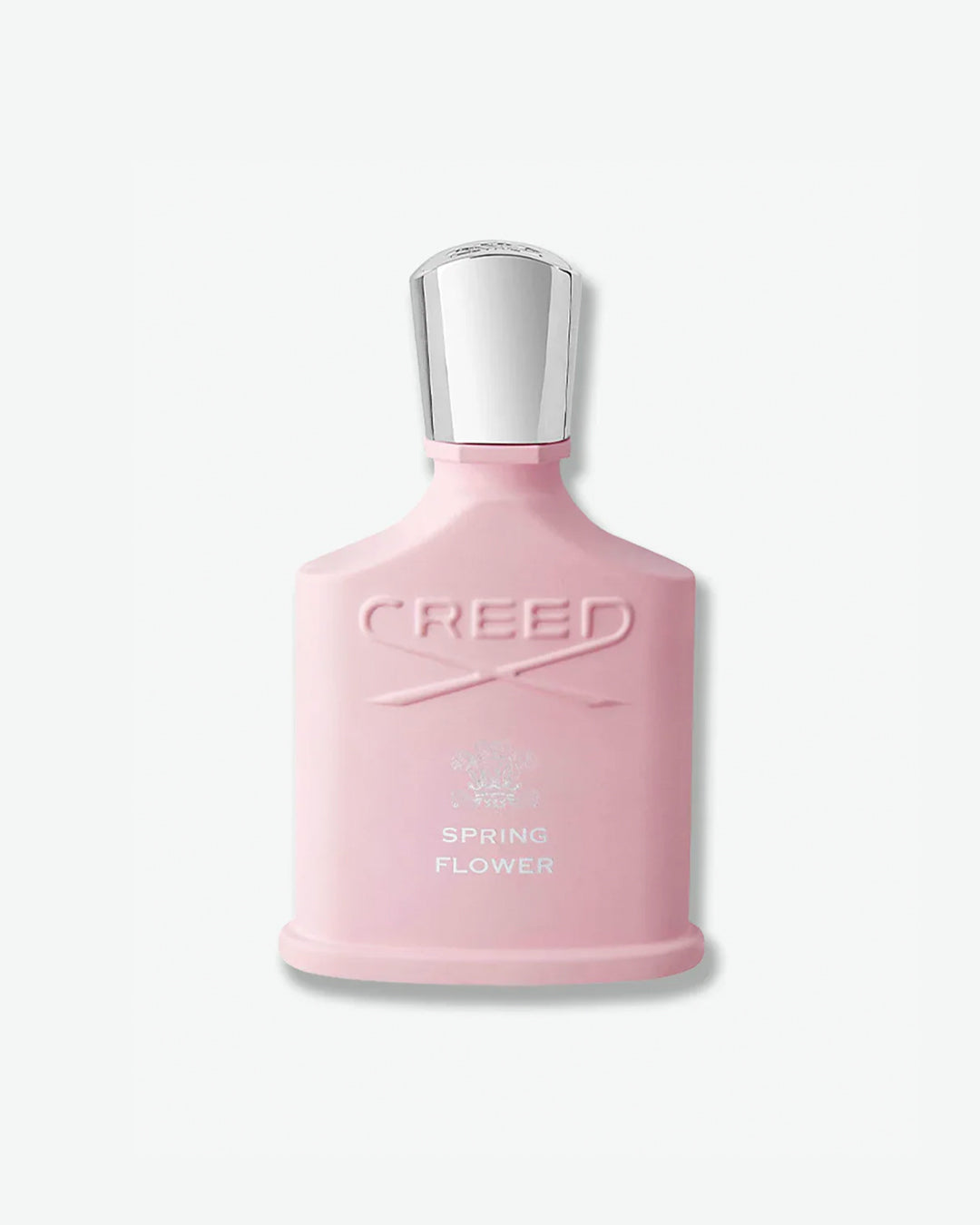Creed Spring Flower Fragrance in a matte pastel pink silhouette bottle featuring an embossed logo and a reflective silver cap, isolated against a light grey background.