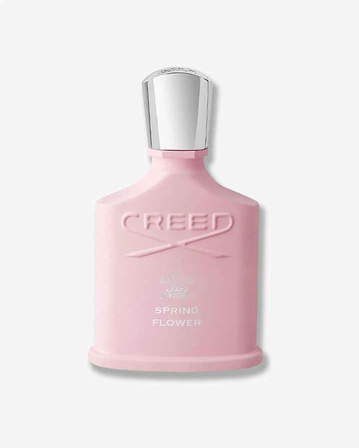 Pink Creed Spring Flower perfume bottle with silver cap on a white background