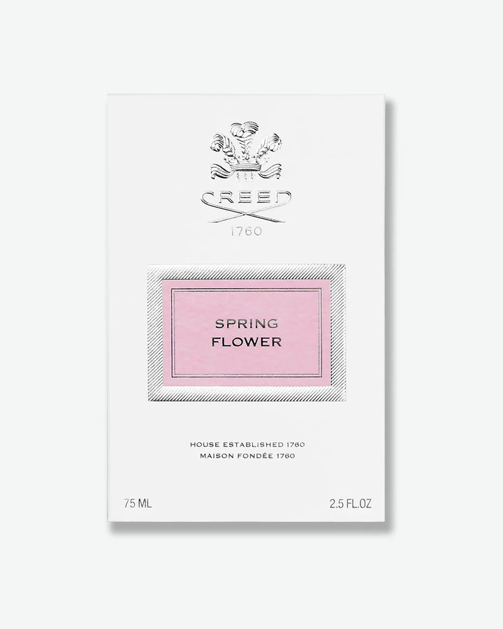 White perfume bottle packaging with silver 'Creed' logo and 'Spring Flower' text on a pink label on a white background
