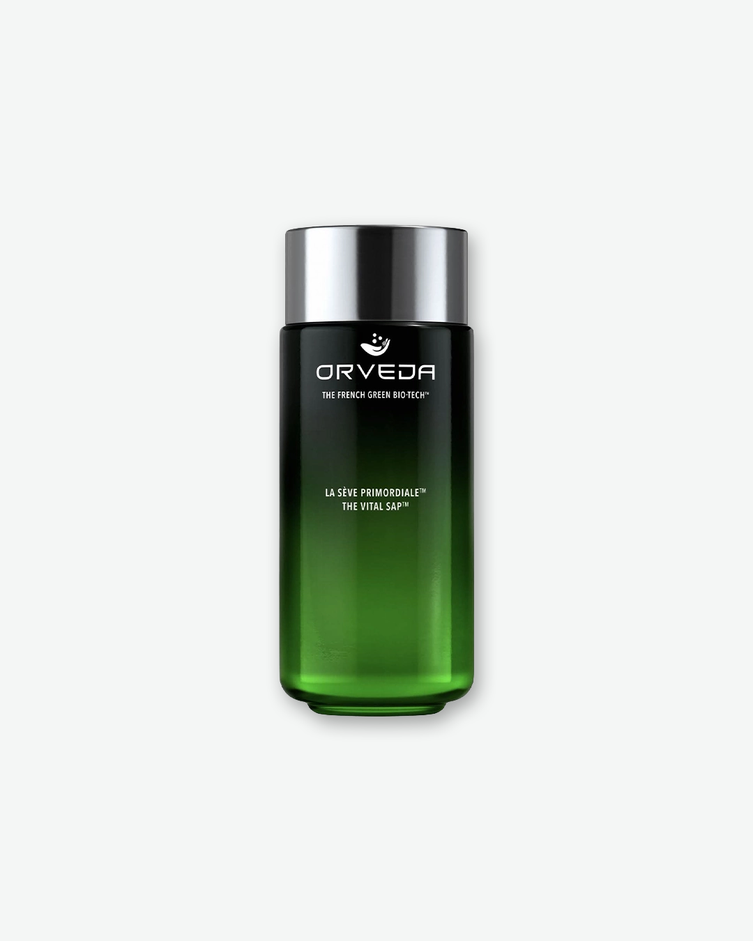 A product shot of an Orveda The Vital Sap bottle, centered against a plain light gray background. The sleek, tall cylindrical glass bottle features a deep ombre green gradient that transitions from a dark, near-black top to a translucent emerald green base. It is sealed with a metallic silver screw cap, and the front displays the white Orveda logo, "THE FRENCH GREEN BIO-TECH™", and the product name "LA SÈVE PRIMORDIALE™ THE VITAL SAP™".