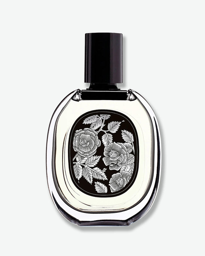 Perfume bottle with floral design on a white background