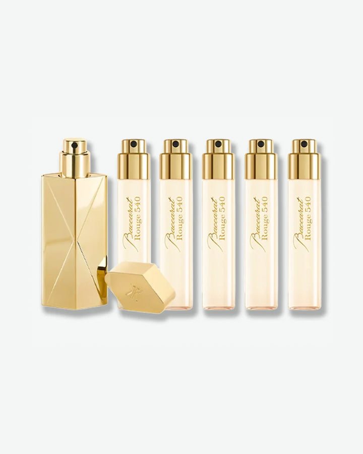 Set of gold perfume bottles featuring Maison Francis Kurkdjian branding on a white background.