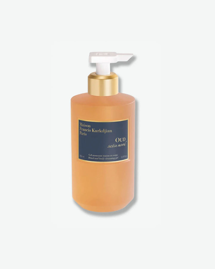 Front view of a translucent amber plastic pump bottle showing a honey-colored liquid gel of Maison Francis Kurkdjian Paris "OUD satin mood" Hand and body cleansing gel (Gel moussant mains et corps) in a 350 ml size, featuring a dark blue and gold label with a gold and white pump mechanism.