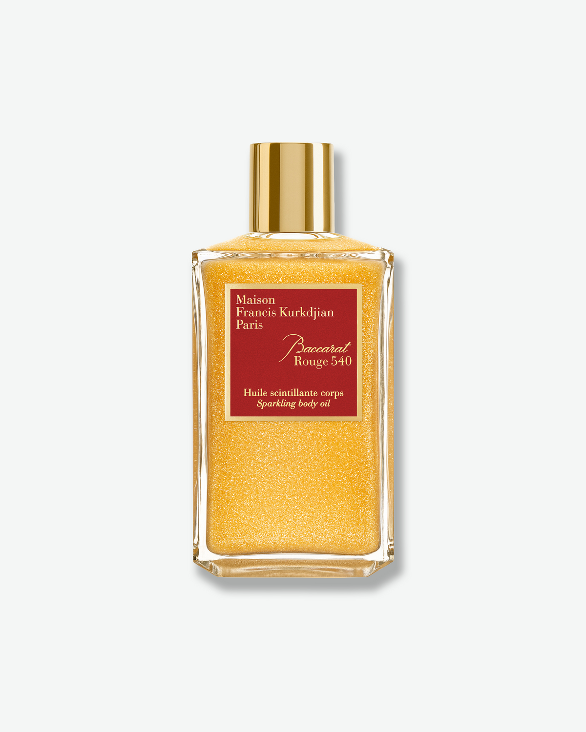 Maison Francis Kurkdjian Baccarat Rouge 540 Sparkling Body Oil in a clear glass bottle filled with shimmering gold oil, finished with a gold cap and signature red label.
