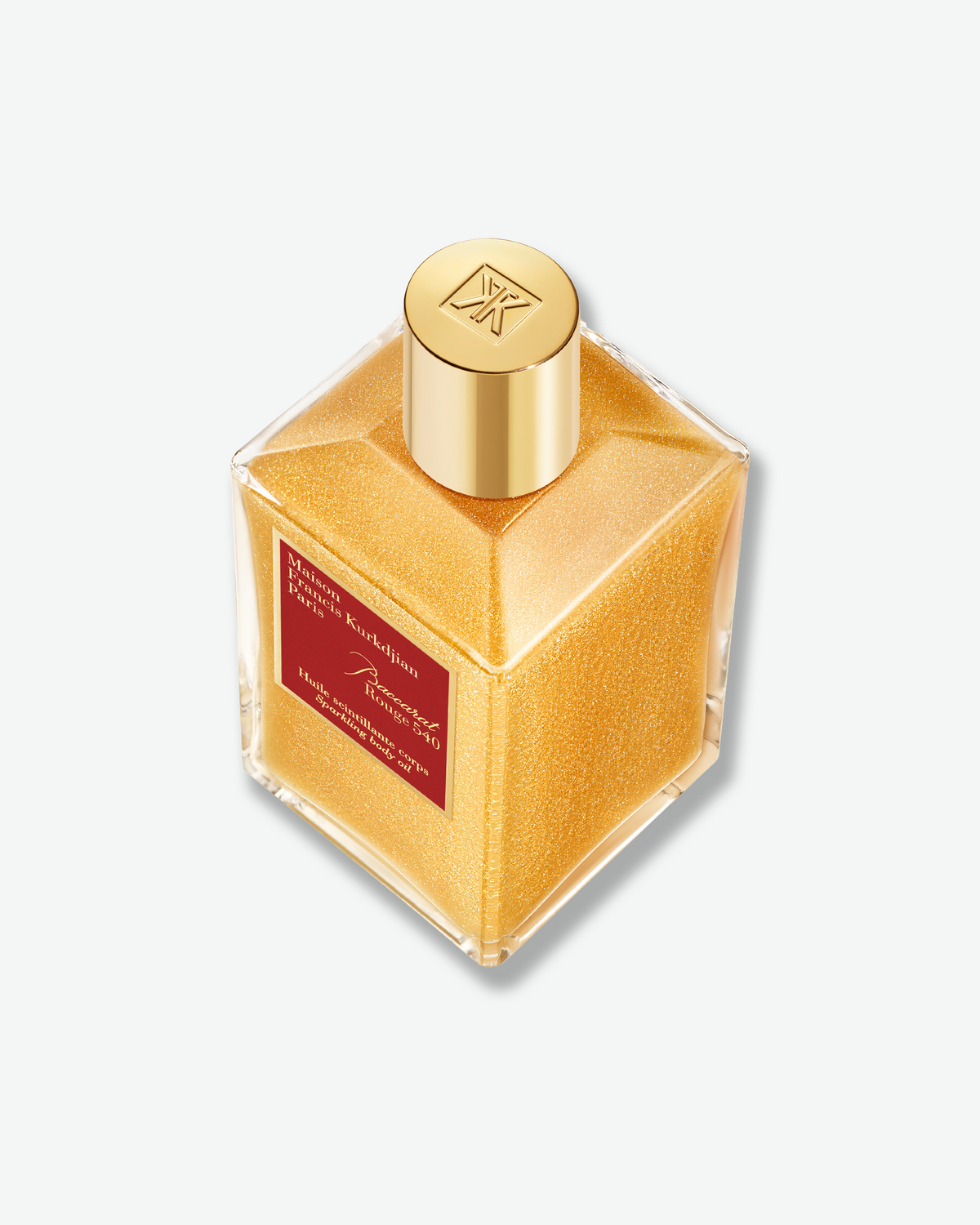 Top-down view of the Baccarat Rouge 540 Sparkling Body Oil, highlighting the luminous gold shimmer suspended throughout the formula and the embossed gold cap.