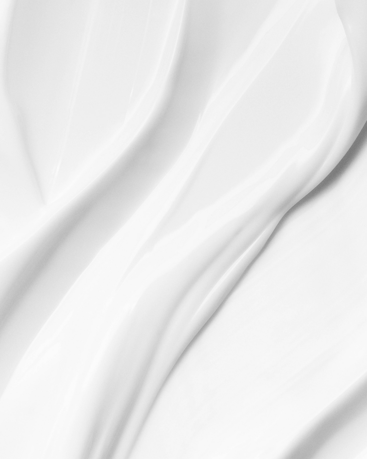 Close-up of the Baccarat Rouge 540 Rich Body Cream texture, showing a smooth, silky white cream with soft flowing swirls.