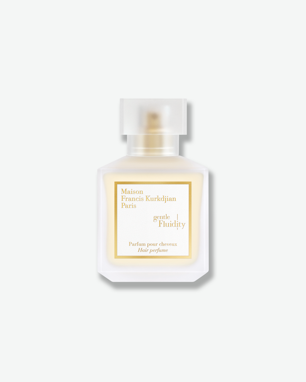 Maison Francis Kurkdjian Gentle Fluidity Hair Perfume in a frosted glass bottle with soft golden fragrance, a translucent cap, and white-and-gold label.